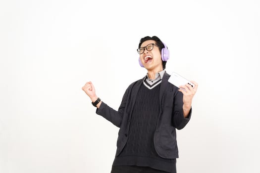 A man in a sweater and headphones is holding a phone photo