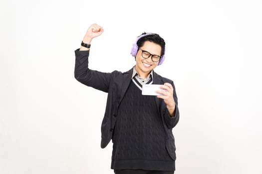 A man in glasses and a sweater holding up a card photo
