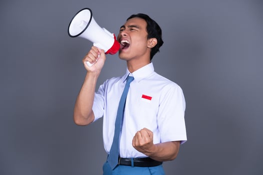 Indonesian Male High School Students in Uniform with Megaphone Background photo