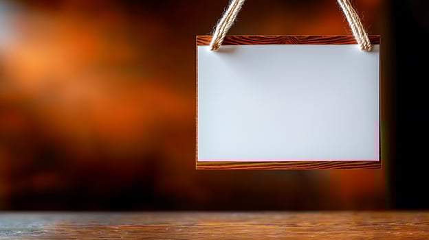 Blank wooden sign hanging against a blurred warm background, ideal for customizable messages photo