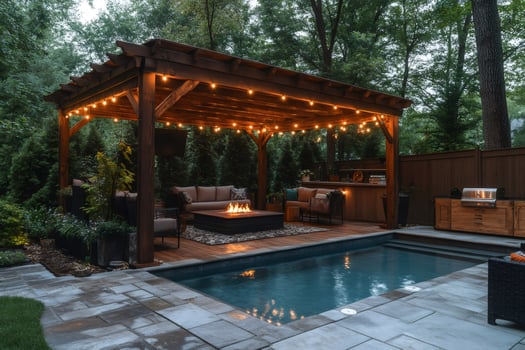 Backyard with pool, wooden pergola, fire pit and string lights illuminating the scene at dusk photo