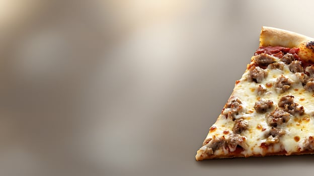 Delicious slice of pizza topped with savory sausage on a blurred background, perfect for food promotion photo