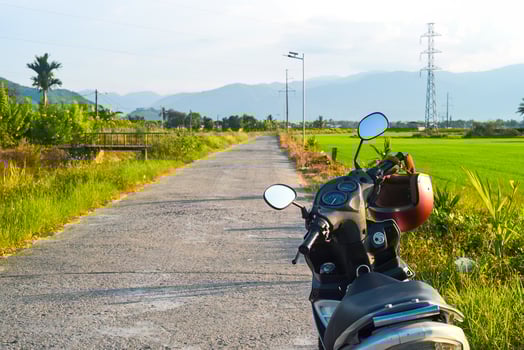 A motorbike on the road among rice fields in Vietnam photo