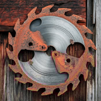 A circular saw blade on a wooden wall photo