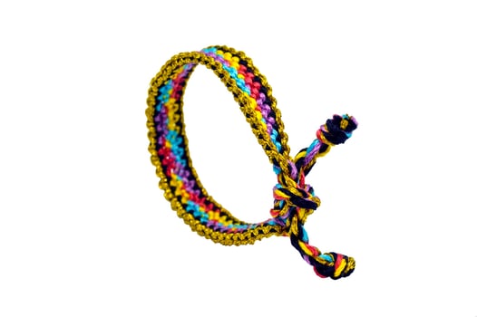 Multicolored bracelet handmade of embroidery bright thread with knots isolated on white background photo