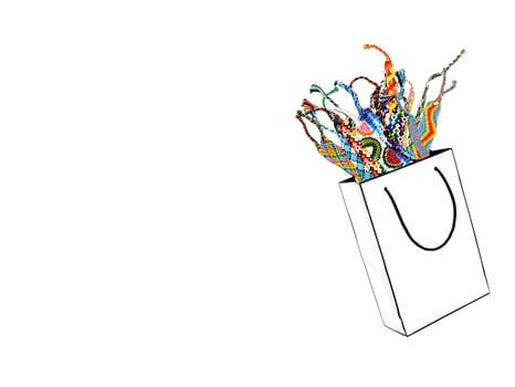 White paper bag with woven multi-colored friendship bracelets isolated on white background photo