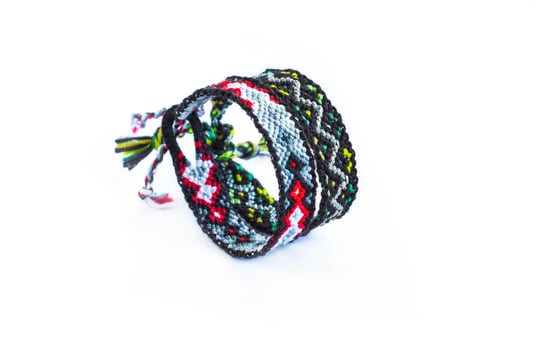 2 woven DIY friendship bracelets handmade of bright thread with knots isolated on white background photo