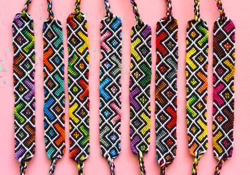 DIY woven similar friendship bracelets with abstract geometric pattern. Summer accessories photo