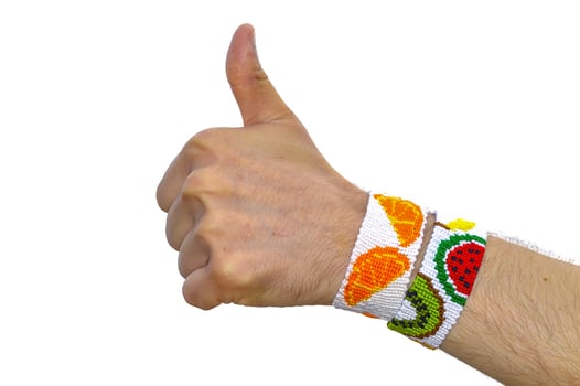 thumbs up gesture with friendship bracelets on wrist. isolated on white background photo