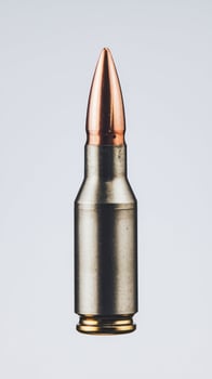 Single rifle bullet isolated on white high resolution photo