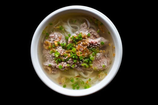 Traditional vietnamese soup Pho bo on black background top view photo