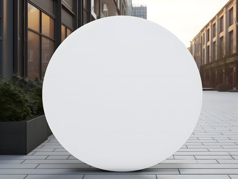 A large white sphere sitting on the sidewalk photo