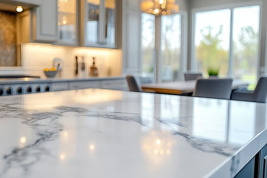 A beautifully designed modern kitchen with a luxurious marble countertop, soft lighting, and a cozy dining area in the background. photo
