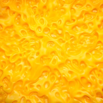 Closeup of a vibrant yellow cheese texture with irregular holes and swirls photo