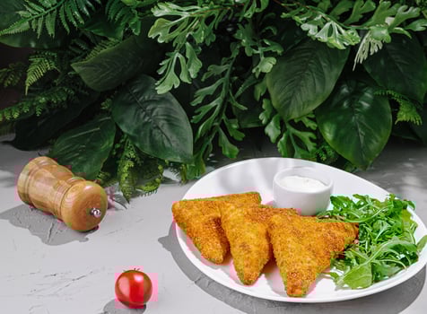 Delicious fried snacks served with fresh greens and sauce photo