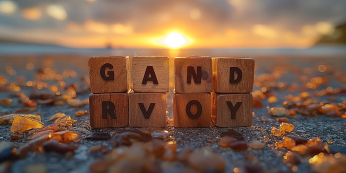 Wooden blocks spelling 'GANDRVOY' on a beach at sunset, surrounded by shimmering stones. photo