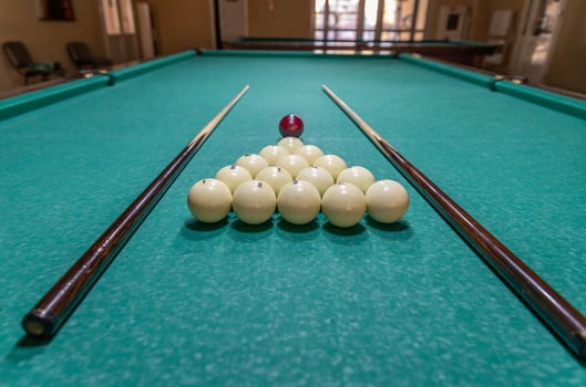 A pool table with balls and sticks on it photo