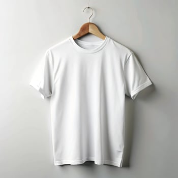 Simple White Crew Neck TShirt Hanging on Wooden Hanger on White Background photo