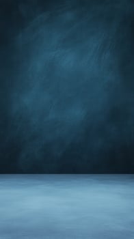 Studio shot of a textured blue wall and floor providing a simple, muted, and elegant backdrop photo