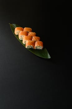 A classic Philadelphia roll with fresh salmon, creamy cheese, and seasoned sushi rice. Perfect for a Japanese menu, this visually appealing sushi is rich in flavor and beautifully presented. photo