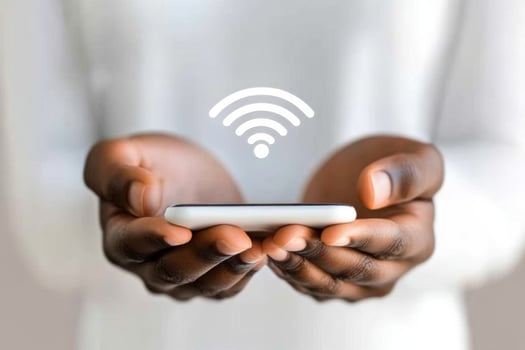 Person holding smartphone with holographic Wi-Fi symbol, representing advanced wireless connectivity in modern technology photo