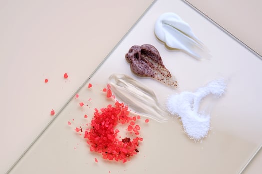 Various cosmetic textures. cream, gel, scrub, bath salt, enzyme powder on a beige background. photo