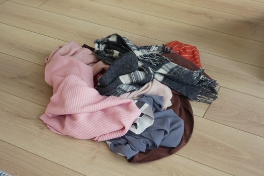 Scattered collection of colorful scarves on wooden floor photo