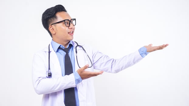 A Young Adults Asian Male Doctor Pose As If Presenting Something on White Background photo