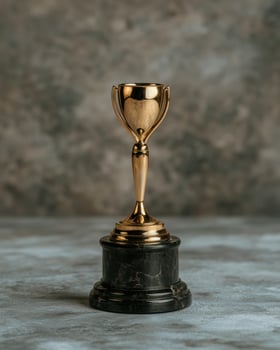 A shiny gold trophy on a marble base photo