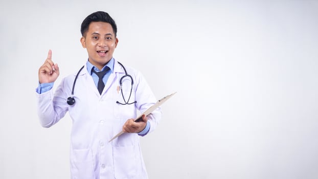 Portrait of Asian Male Doctor Showing Get Good Idea Pose with Copy Space on White Background photo