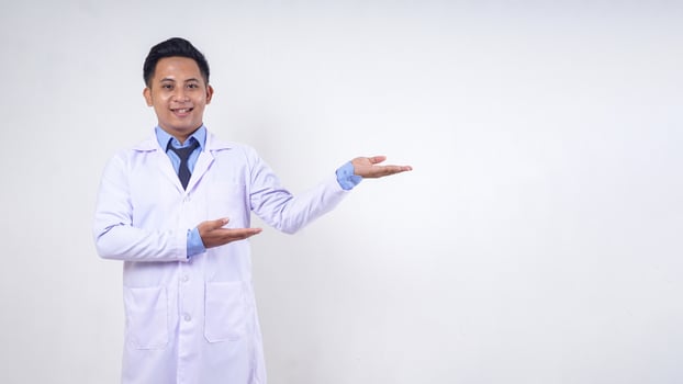 Portrait of Handsome Asian Male Doctor Presenting Something on White Background photo