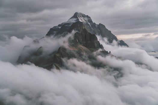 Majestic Mountain Peak Enveloped in a Sea of Clouds Dramatic Landscape Photography photo