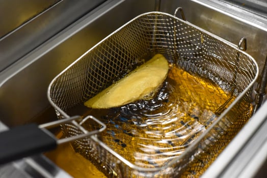 Corn quesadilla frying in oil for tacos in a mexican restaurant photo