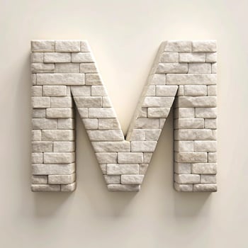A three dimensional stone brick letter M against a beige background photo