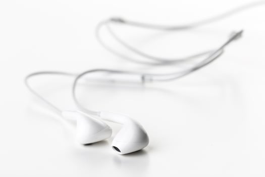 Pair of earphones close up on grey background photo