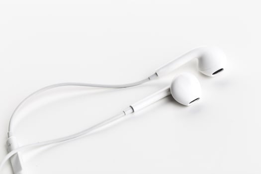 Pair of earphones close up on grey background photo