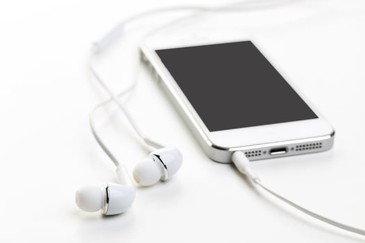 Smartphone with black screen with earphones close up photo