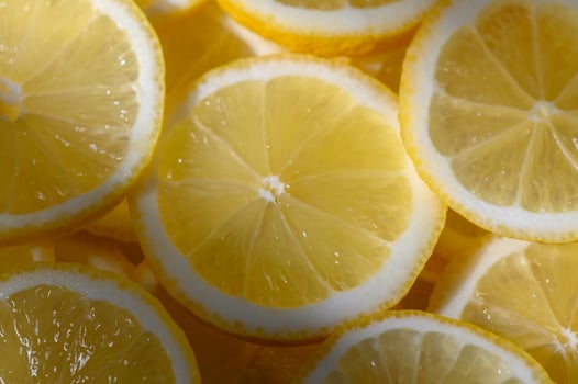 Freshly sliced lemons offer a vibrant touch to culinary creations and refreshing beverages photo