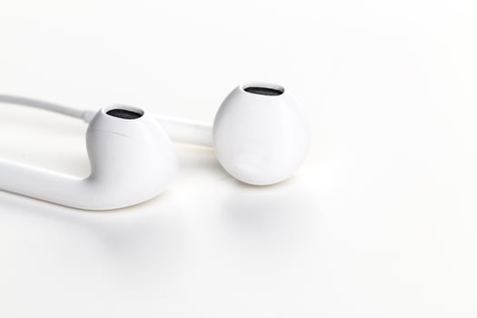 Pair of earphones close up on grey background photo