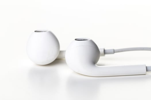 Pair of earphones close up on grey background photo