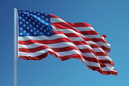 Waving proudly in the blue sky, the American flag symbolizes freedom and unity. photo
