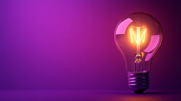 A light bulb is glowing in a purple light photo