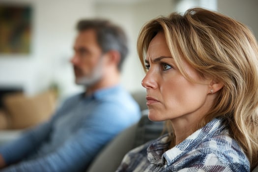 Tension between a couple during a serious conversation in a cozy living room setting photo