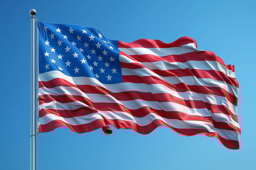 Waving symbol of freedom captured against a bright blue sky at midday. photo
