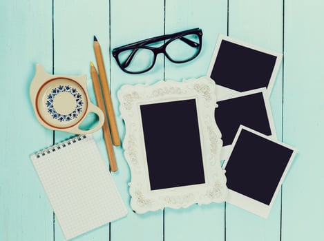 Stationery and personal items arranged on a light wooden table for creative planning and memory keeping photo