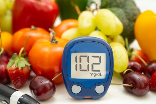 Asian hand holding digital glucose monitor measure photo