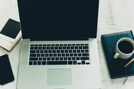 Workplace with laptop, notepad and coffee cup on white background photo