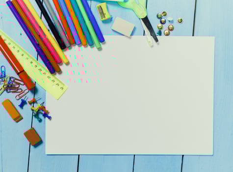 Creative workspace with colorful stationery and blank paper for art projects at home photo