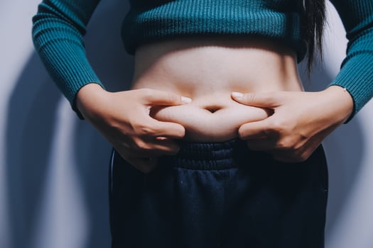 A woman with her hands on her stomach photo