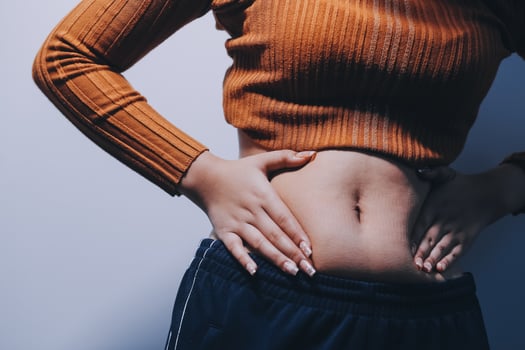 A woman with her hands on her stomach photo